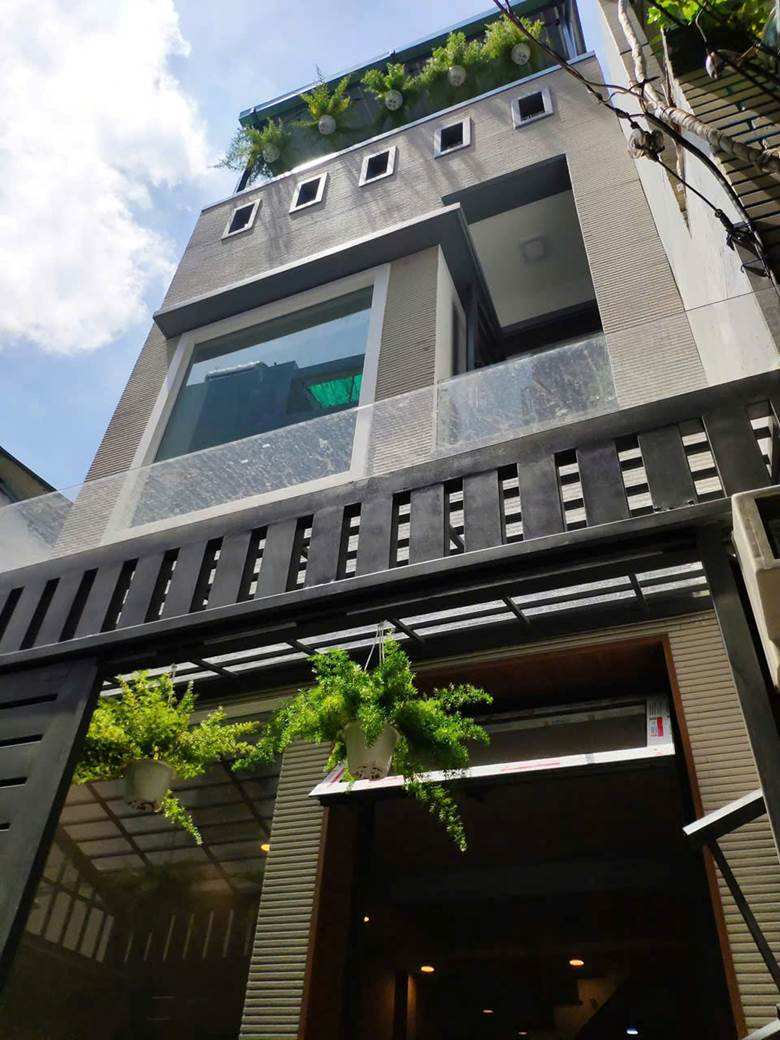 A building with plants on the frontAI-generated content may be incorrect.